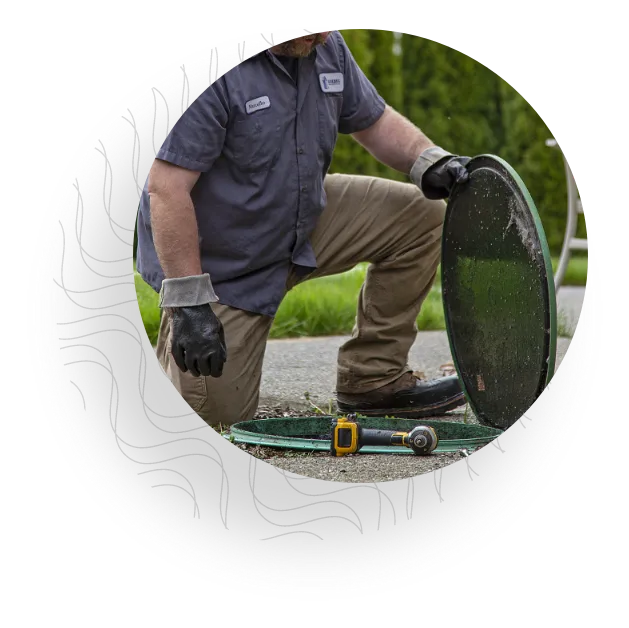 Service man inspecting septic system.