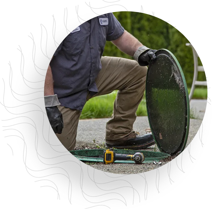 A serviceman inspecting septic system.