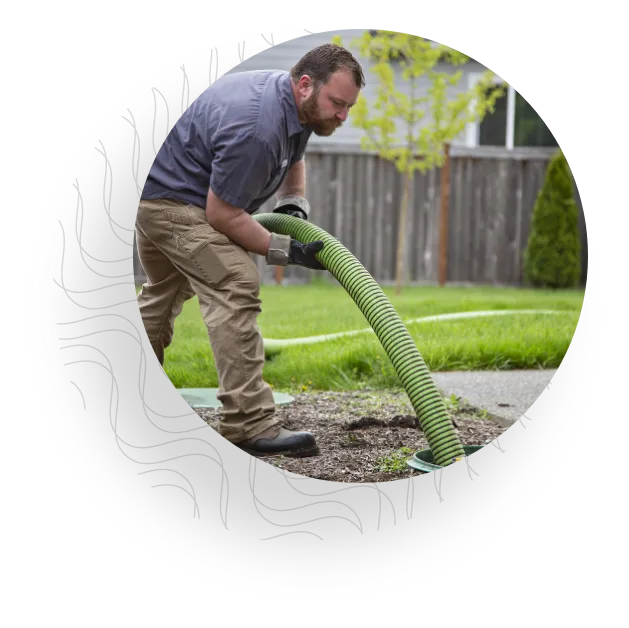 Service man pumping septic tank.